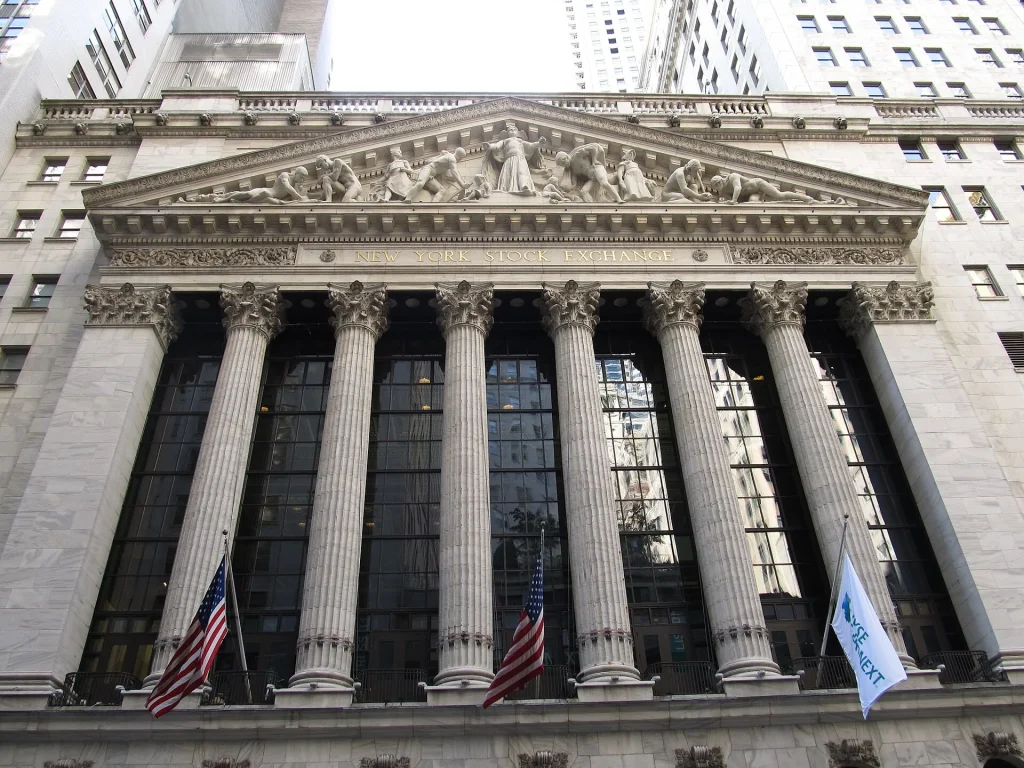 The AI Bubble Debate Explained: Hype, Earnings and Real Demand Traders and financial data screens in a busy stock market setting