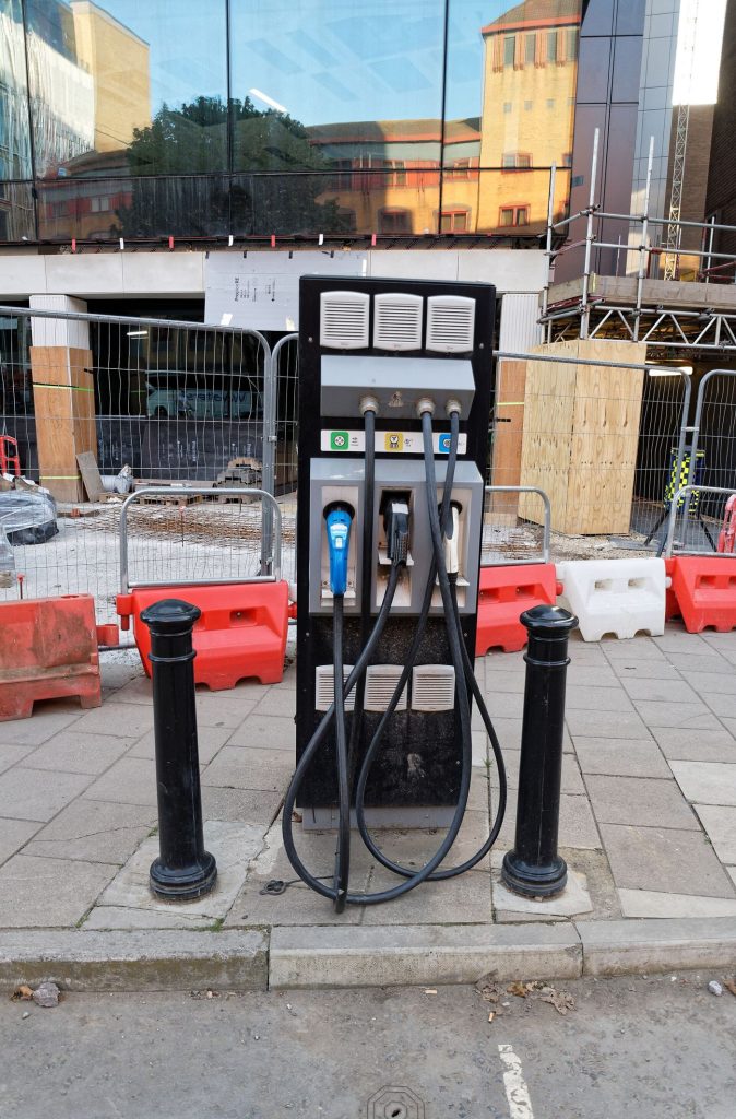 An electric car charging on a city street