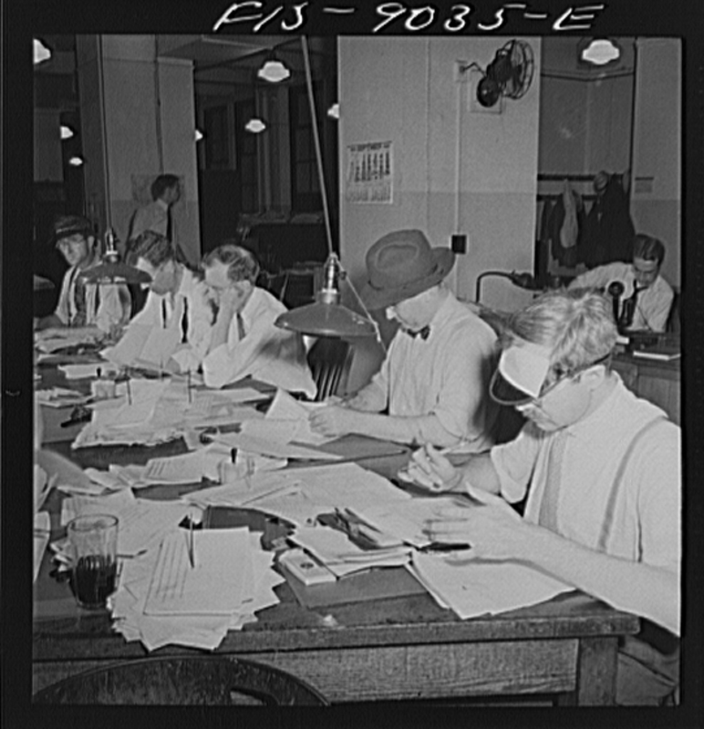 Small Newsrooms Are Using AI to Publish Faster Journalists working at desks with computers in a busy newspaper newsroom